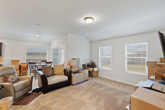 living room featuring vaulted ceiling and light colored carpet