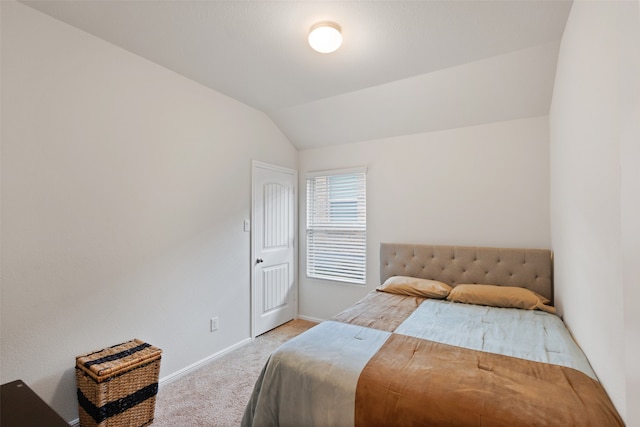 bedroom with light carpet and vaulted ceiling