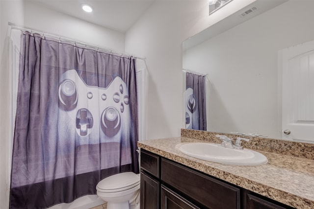 full bathroom with vanity, shower / bath combo, and toilet