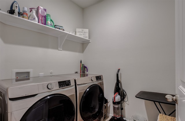 clothes washing area with washing machine and clothes dryer