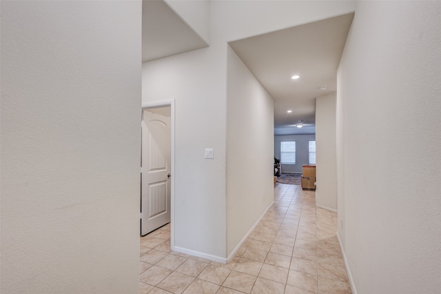 hall with light tile patterned floors