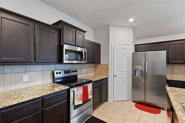 kitchen with dark brown cabinetry, light tile patterned flooring, backsplash, and appliances with stainless steel finishes