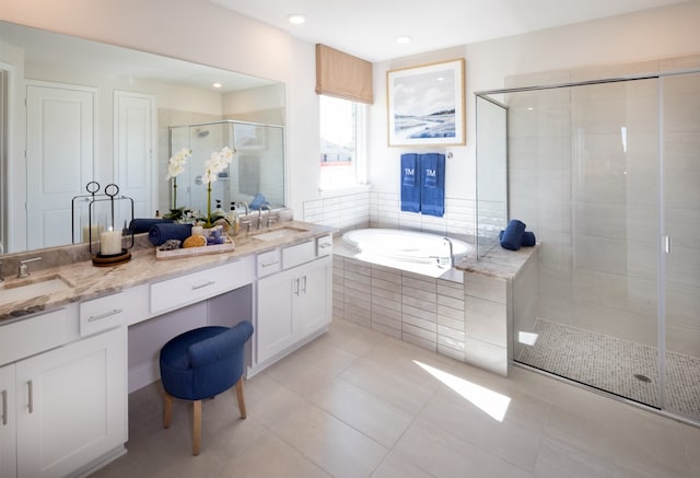 bathroom with tile patterned flooring, vanity, and shower with separate bathtub