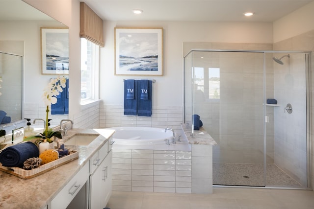 bathroom with vanity, independent shower and bath, and tile patterned floors