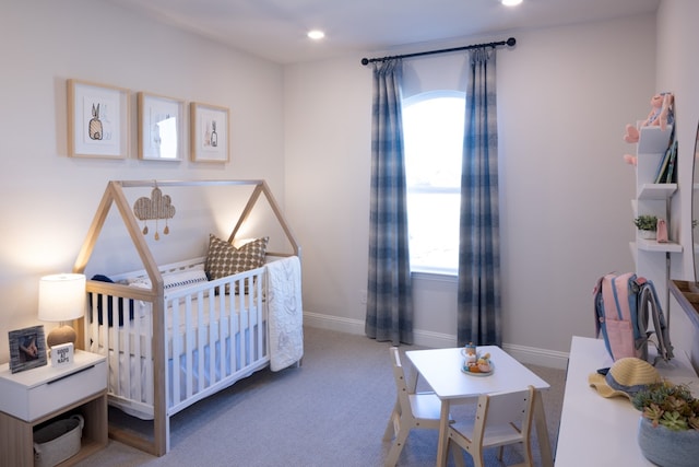 bedroom with carpet and a crib