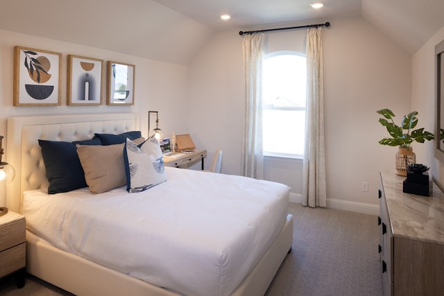 carpeted bedroom with vaulted ceiling