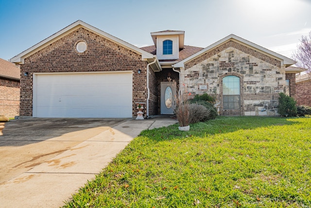 view of front of property featuring a garage and a front lawn