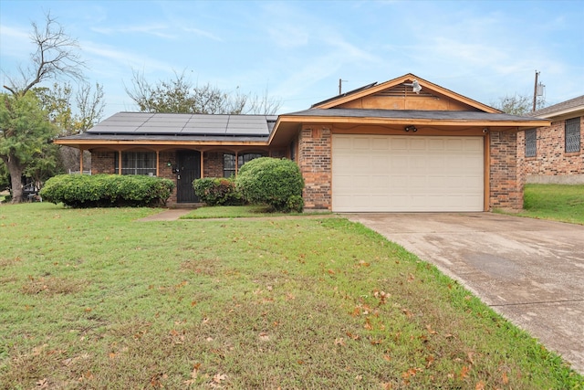 ranch-style home featuring a garage, solar panels, a front yard, and a porch