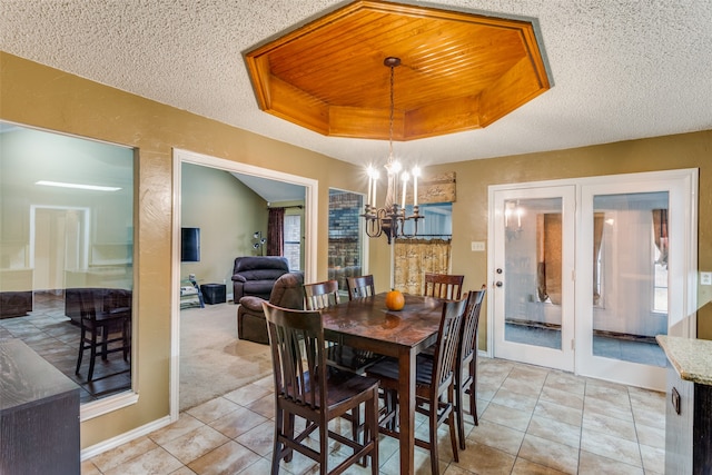 dining space with light carpet, a textured ceiling, and a notable chandelier