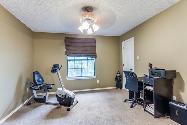 carpeted office featuring ceiling fan and a textured ceiling