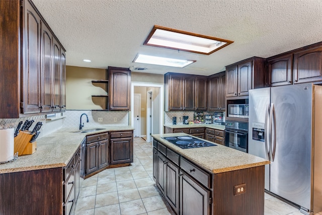 kitchen with black appliances, dark brown cabinetry, and sink