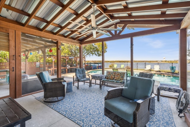 sunroom / solarium with ceiling fan and lofted ceiling with beams