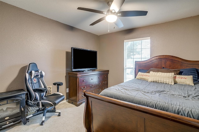 bedroom featuring ceiling fan and light carpet