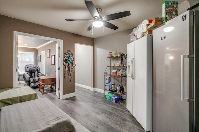 bedroom featuring ceiling fan, crown molding, white refrigerator, dark hardwood / wood-style floors, and white fridge with ice dispenser