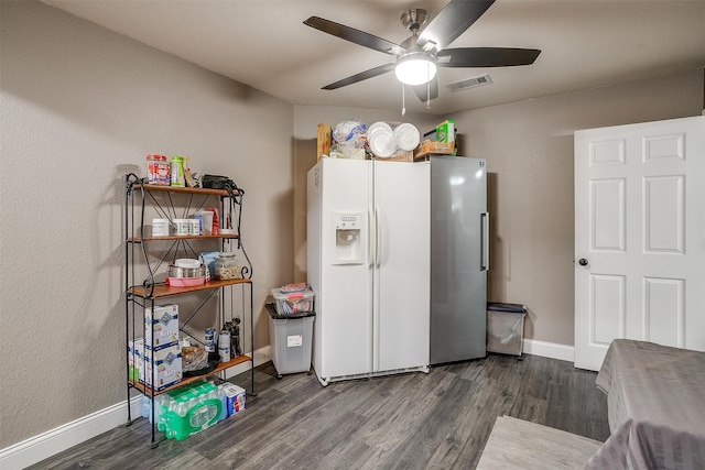 interior space featuring ceiling fan, white fridge with ice dispenser, and dark hardwood / wood-style floors