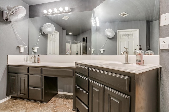 bathroom featuring vanity, tile patterned floors, and a shower with door