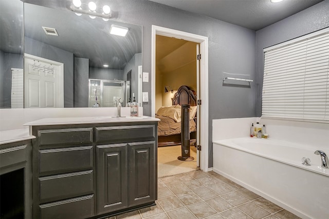 bathroom featuring tile patterned flooring, vanity, and independent shower and bath