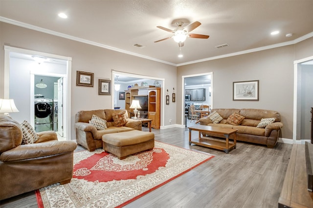 living room with crown molding, hardwood / wood-style floors, and ceiling fan