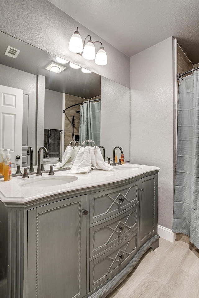 bathroom with vanity and a textured ceiling