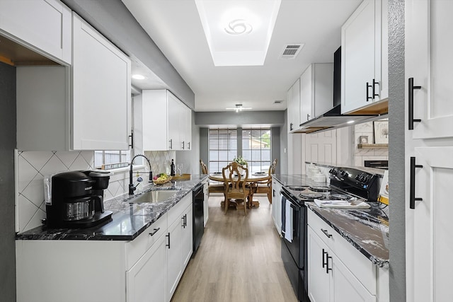 kitchen featuring black appliances, sink, dark stone countertops, and white cabinets