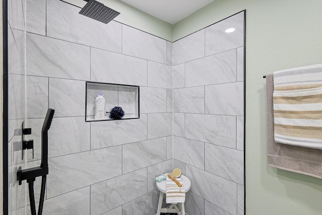 bathroom with tiled shower