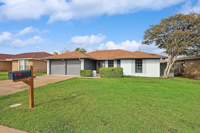 ranch-style house featuring a garage and a front lawn