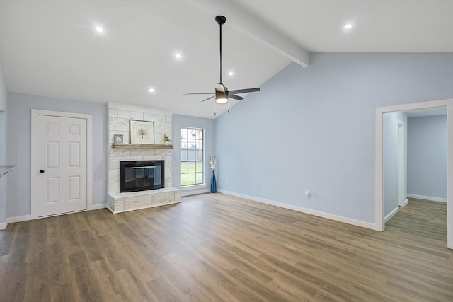 unfurnished living room with wood-type flooring, high vaulted ceiling, a large fireplace, beamed ceiling, and ceiling fan