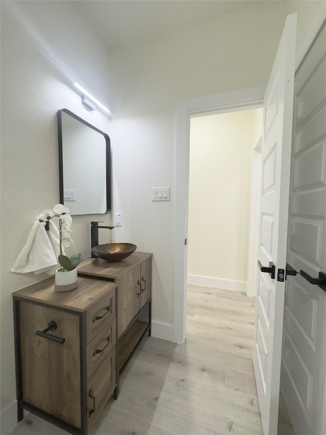 bathroom with hardwood / wood-style floors and vanity