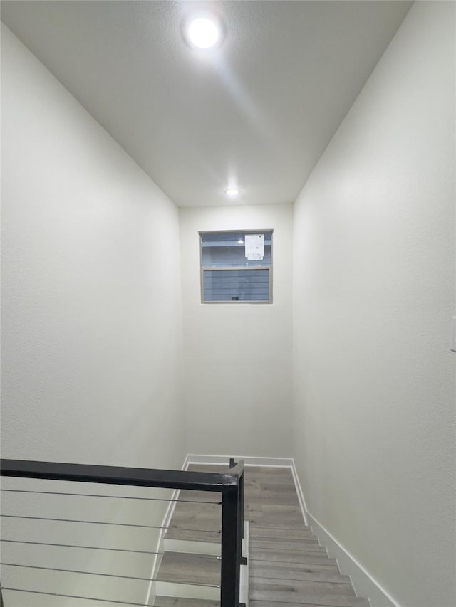 stairway featuring hardwood / wood-style flooring