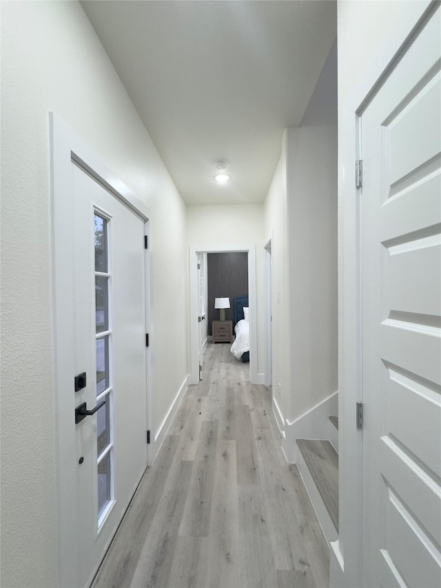 hall with light hardwood / wood-style flooring