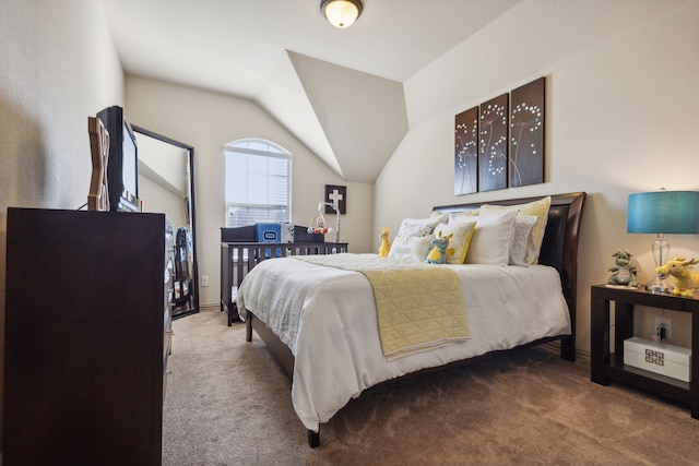 carpeted bedroom featuring lofted ceiling