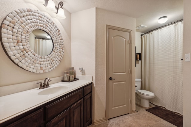 bathroom with toilet and vanity