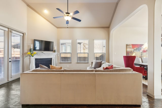 living room with ceiling fan, crown molding, and vaulted ceiling