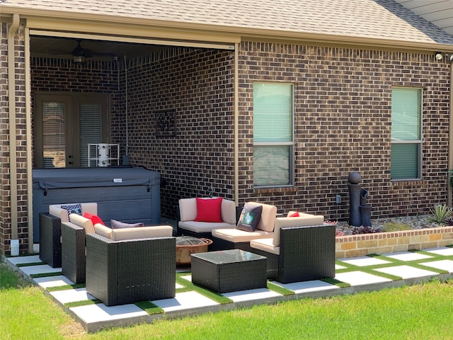 view of patio / terrace with an outdoor living space and a hot tub