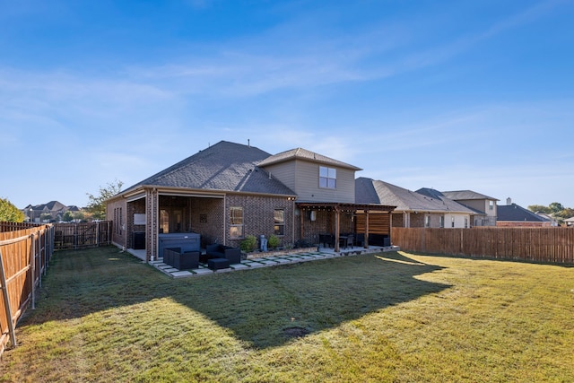 rear view of house featuring a lawn, a hot tub, and a patio area