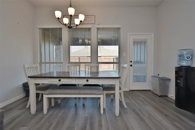 dining space featuring a chandelier and wood-type flooring