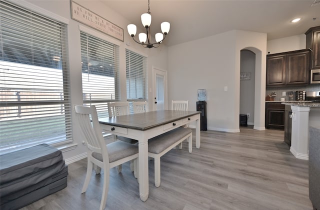 dining room featuring light hardwood / wood-style flooring and a chandelier