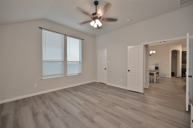 interior space featuring light hardwood / wood-style floors, lofted ceiling, and ceiling fan