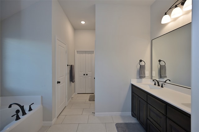 bathroom featuring a washtub, vanity, and tile patterned floors