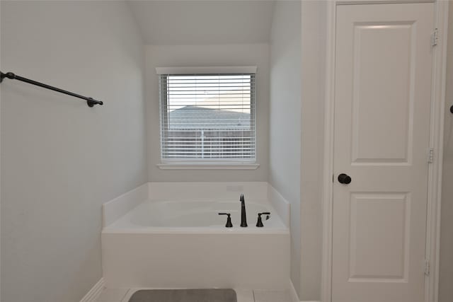 bathroom featuring a bath and tile patterned floors