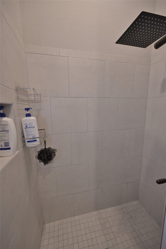 bathroom with tiled shower