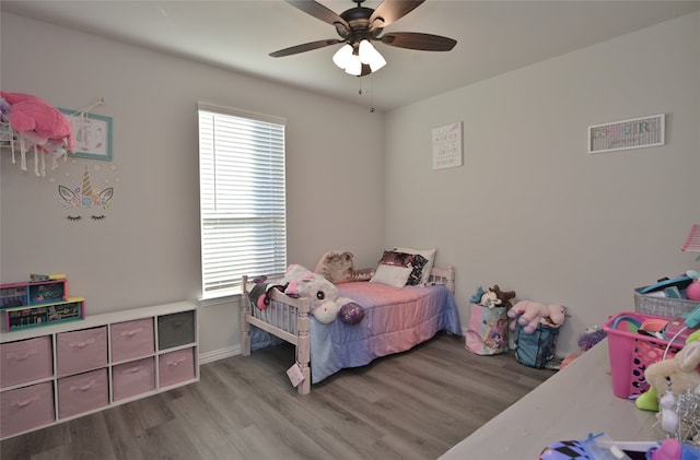 bedroom featuring hardwood / wood-style floors and ceiling fan