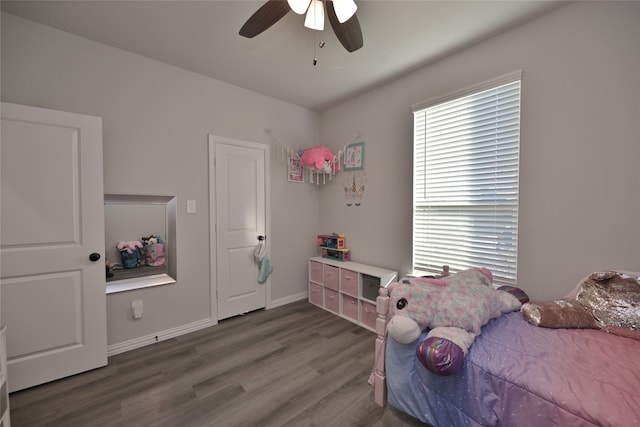 bedroom with dark wood-type flooring and ceiling fan