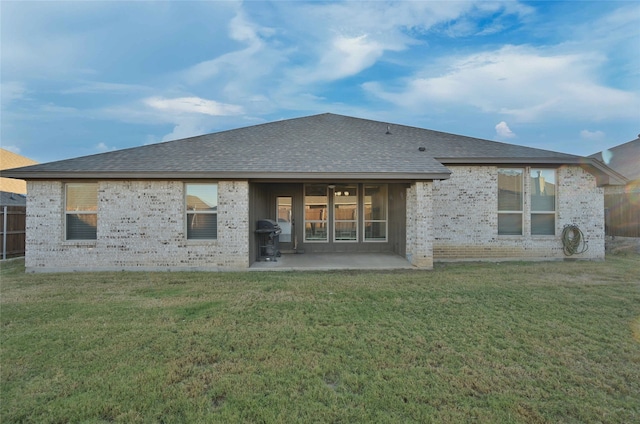 back of house featuring a patio and a lawn