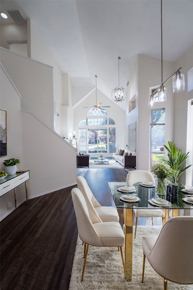 dining area with hardwood / wood-style flooring, high vaulted ceiling, ceiling fan, and a wealth of natural light