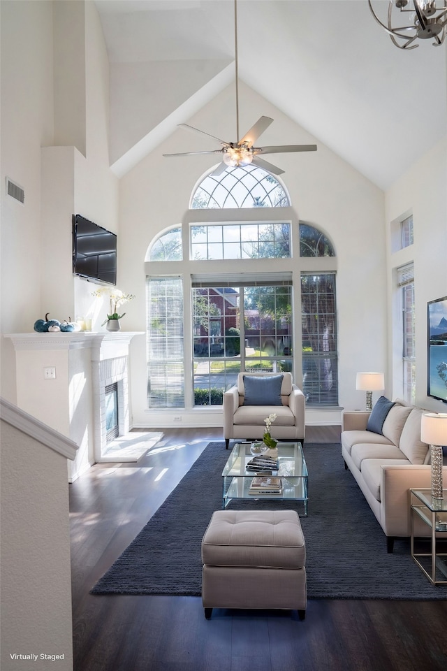 living room featuring ceiling fan, dark hardwood / wood-style flooring, and high vaulted ceiling