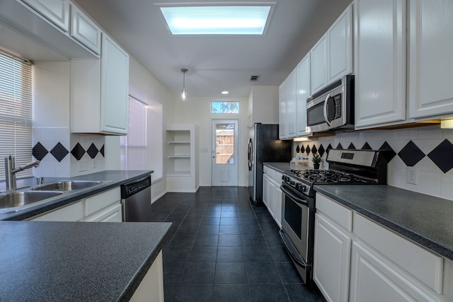 kitchen featuring backsplash, white cabinetry, sink, and stainless steel appliances