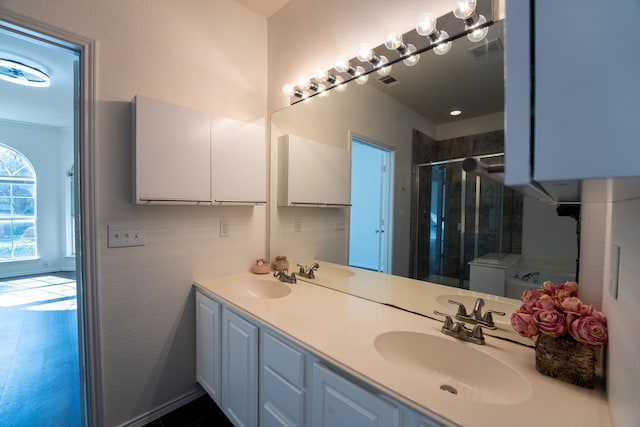 bathroom featuring vanity and a shower with shower door