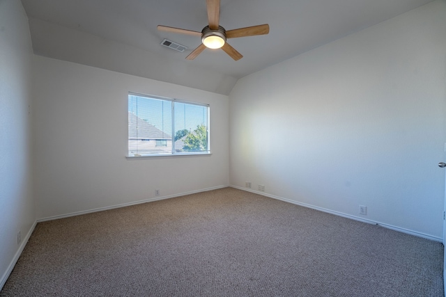 empty room featuring carpet, ceiling fan, and vaulted ceiling