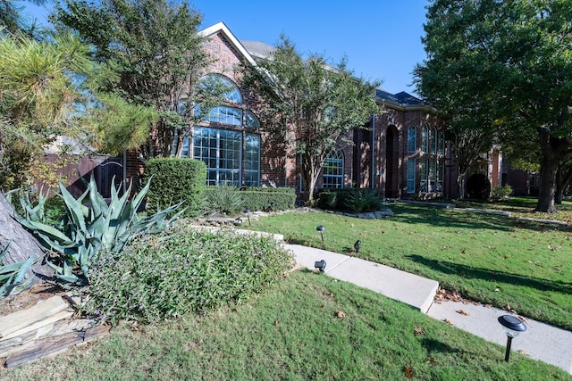 obstructed view of property featuring a front yard